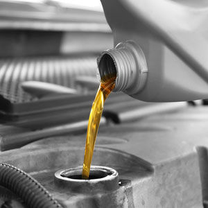 Oil being poured into auto